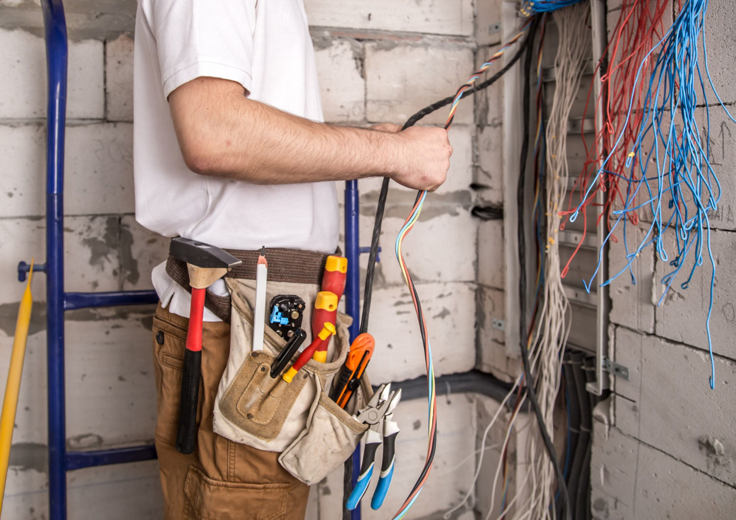 electrician working near board with wires installation connection electrics